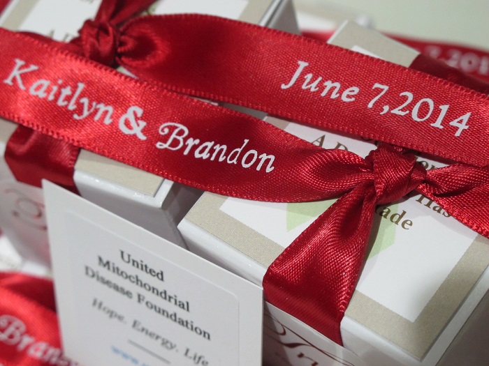 Close up of Kaitlyn & Brandon's scarlet ribbons - chocolate wedding favors for United Mitochondrial Disease Foundation.