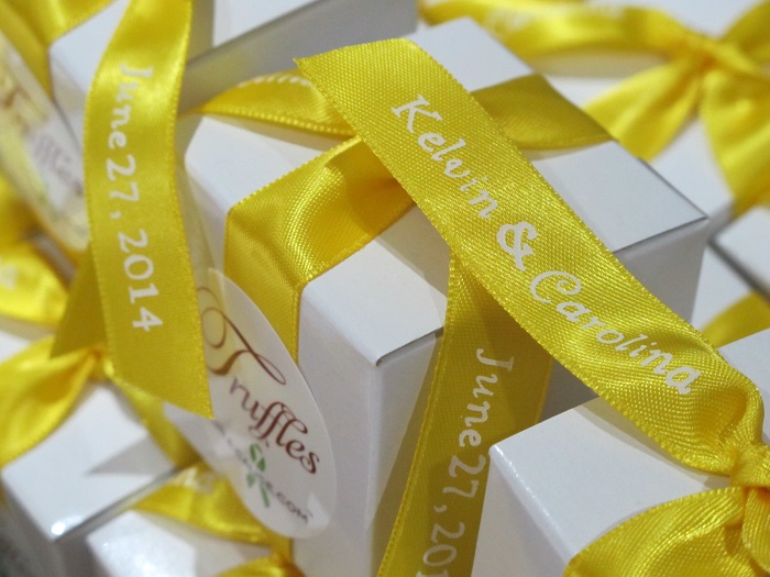 Close up of lemon yellow printed ribbons for Kelvin & Carolina with Lupus Foundation donation.