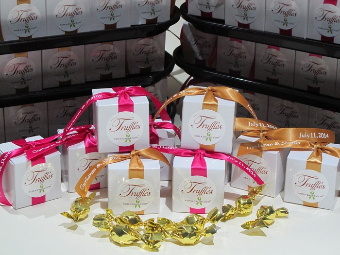Front group photo of azalea & gold ribbons on white favor boxes - chocolate wedding favors for National Brain Tumor Society & American Cancer Society