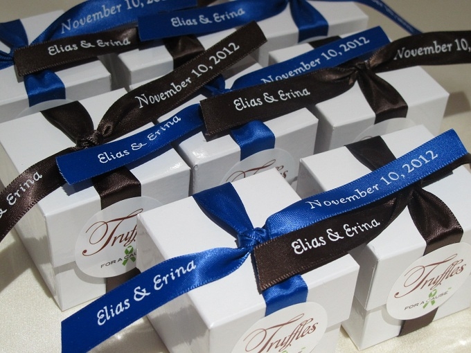 Brown & Royal Blue ribbons on white boxes with raspberry chocolate foil truffles inside. 