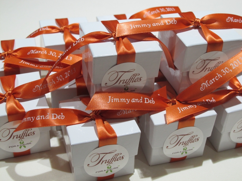 Burnt Sienna ribbons tied on white favor boxes with chocolate mini truffles inside.