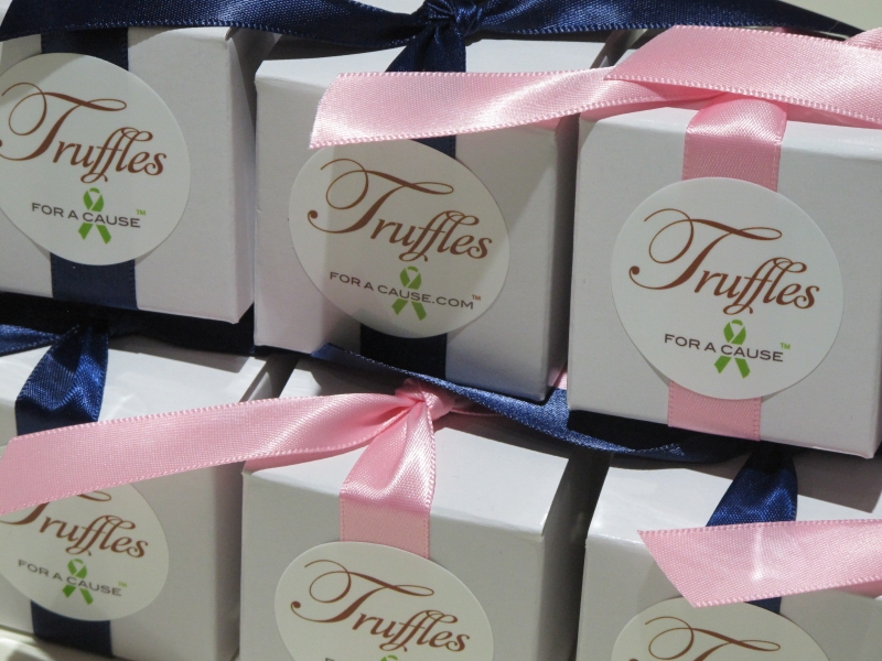 Close up of navy & pink ribbons on white one piece favor boxes with chocolate amaretto truffles inside.