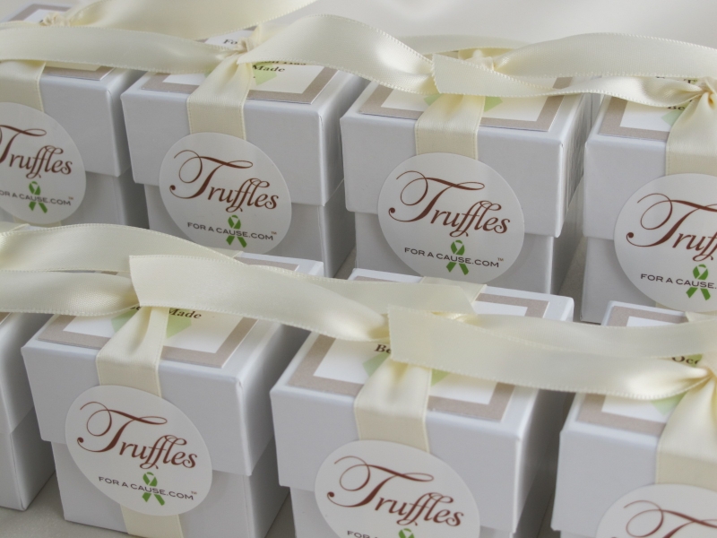 Plain white ribbons on white dessert favors with jumbo chocolate dessert truffles - stacked and ready for shipping.